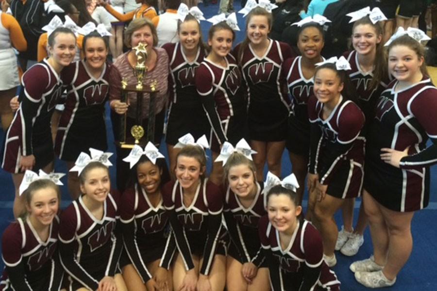 The cheerleading team gathered after winning first place in their division.