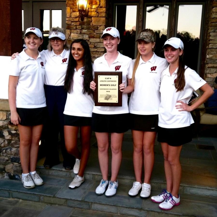 The+womens+golf+team+takes+a+picture+with+the+2015+Cap-8+Conference+trophy.