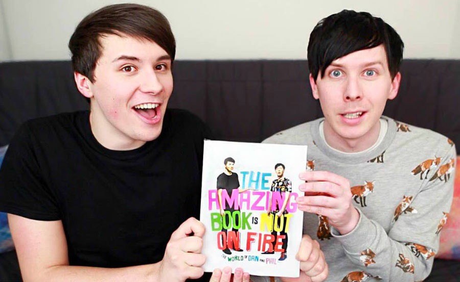 Dan Howell (left) and Phil Lester (right) enthusiastically showcase their achievement.