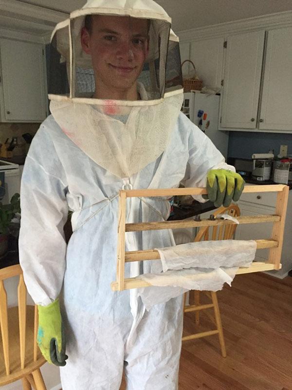 Former Wakefield student Hayden Schug prepares to have an experience with bees. 