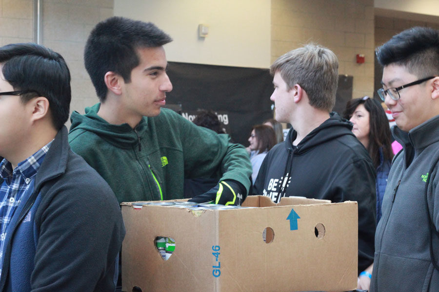 Students helping with canned food donations at Mistletoe Market. 