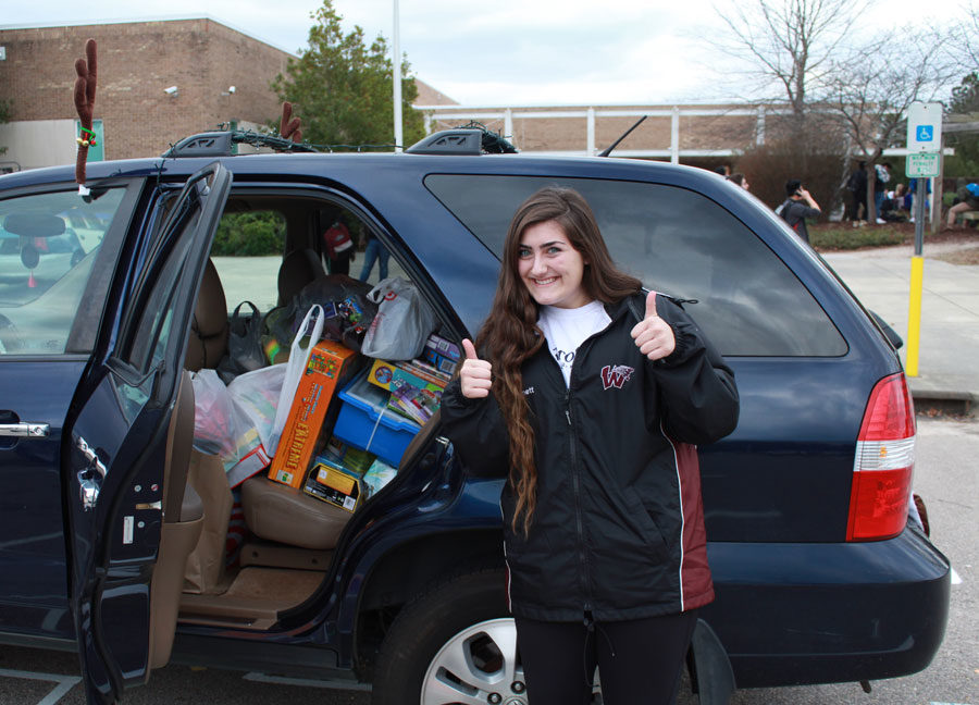 Senior, Macy Bonnet poses with the donations she collected for Beta Clubs Christmas drive. 