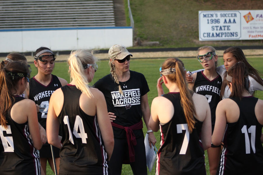 Coach Grasso talks to players during a timeout about their game plan against Wake Forest. 