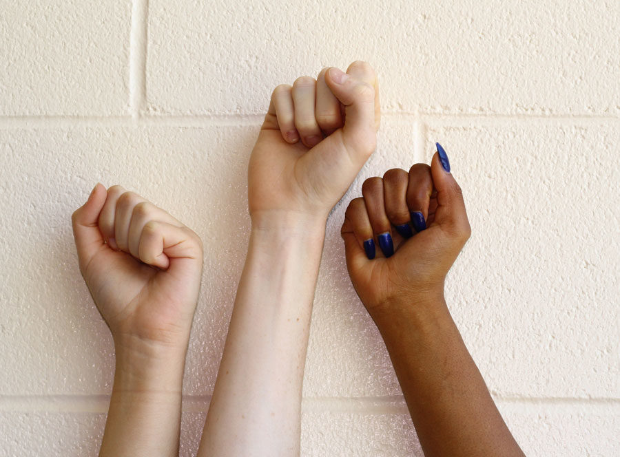 Students put up their fists in solidarity with the #metoo movement. 