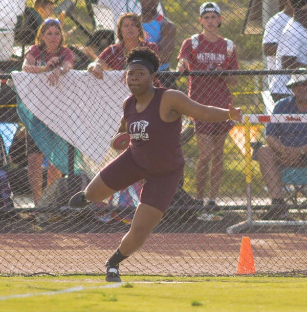 Senior, Veronica Fraley in the midst of throwing a discus.