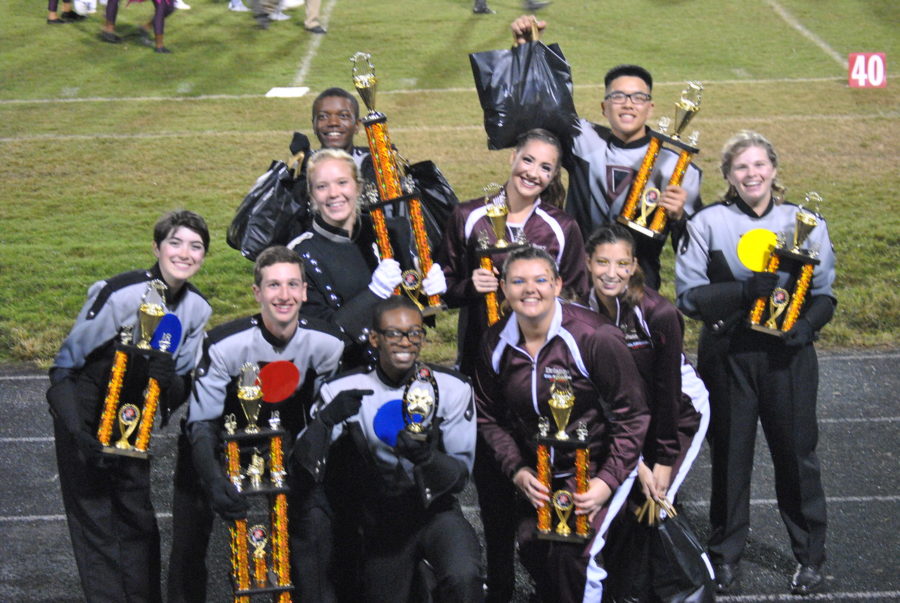 Marching+band+and+color+guard+student+leaders+pose+with+their+trophies.