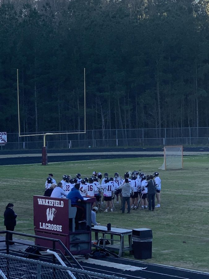The Wakefield lacrosse team huddles up for a team meeting.