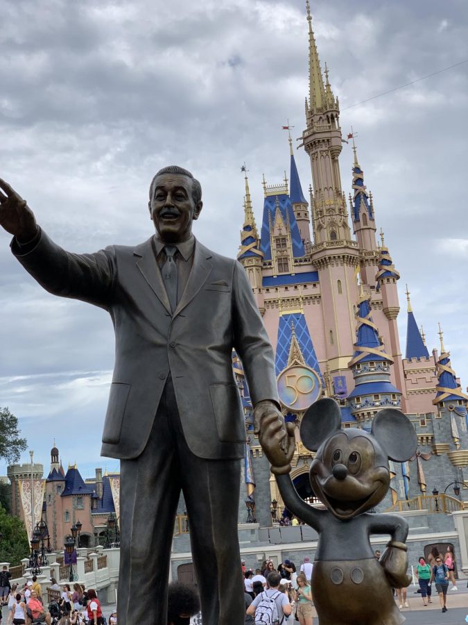 Walt Disneys statue stands in front of Cinderellas castle decorated for the 50th anniversary.