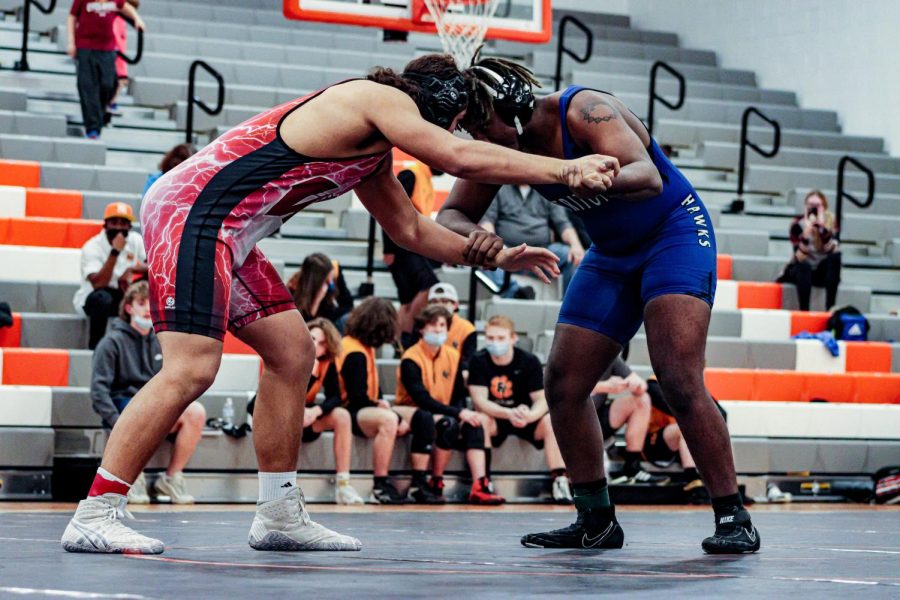 A Wakefield wrestler is in the middle of a match with his opponent, focused on obtaining victory.