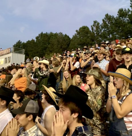 In the stands, students are dressed in their best country gear as they yell supportive chants to their players. Seniors line the fence while juniors, sophomores and freshmen fill the rest of the bleachers. 