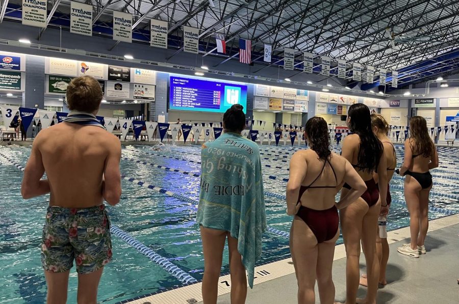Swimmers cheer on their teammates at the meet. Many swimmers enjoy encouraging their friends, as it makes the meets more fun. 