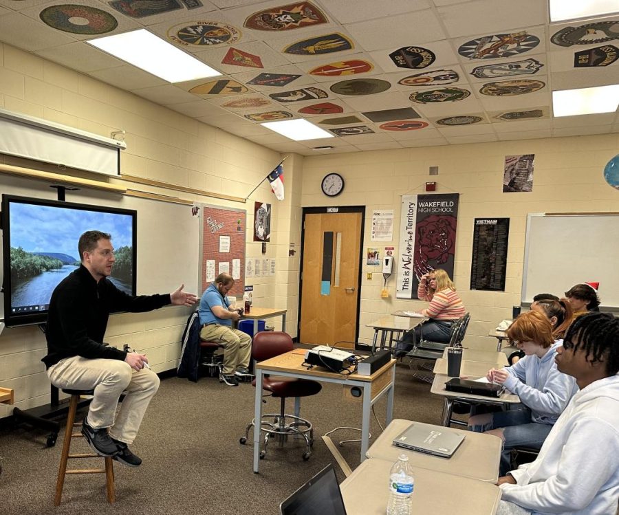 Kyle Bayer chats with his students in his first period class before going into his lesson on supply and demand. Bayer is in his eighth year of teaching.