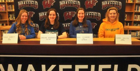 Four WHS committed athletes sit at the table on winter signing day. They are incredibly excited for what their futures hold. 