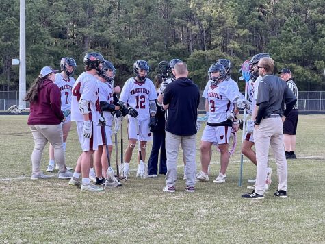 Wakefield Mens Lacrosse team gather around their coaches to discuss a play. The team claims its fun to play together and be a family. 