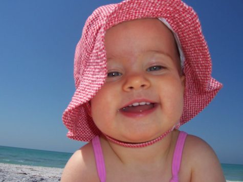 Millie Monahan grins for the camera while on her first trip to the beach