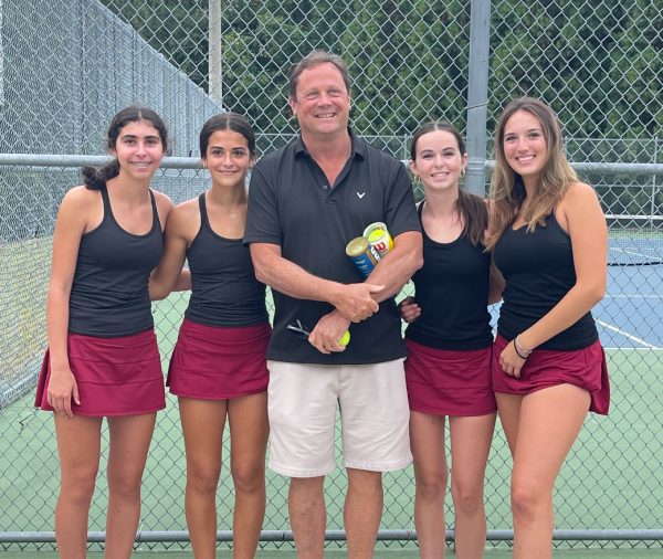 Elsa Weiner, Maya El-Kaissi, Coach Stewart, Maya Raftery, and co-captain Sophie Hanna line up for a picture at one of their matches. The close nature of this team drives the team to success both on and off the court. 
(Photo Courtesy of Julie Raftery)