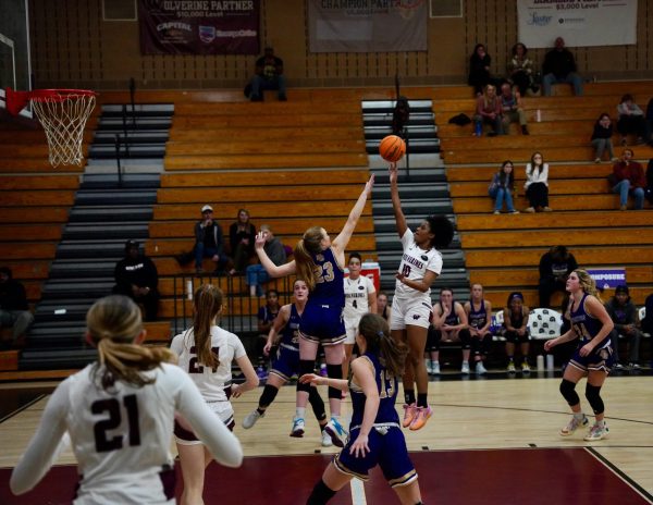 Junior Jaya Hamilton jumps in the air, gearing up for a score at Wakefields game against Broughton High School. Filled with the drive to win, these Lady Wolverines will stop at nothing to achieve their dreams. 