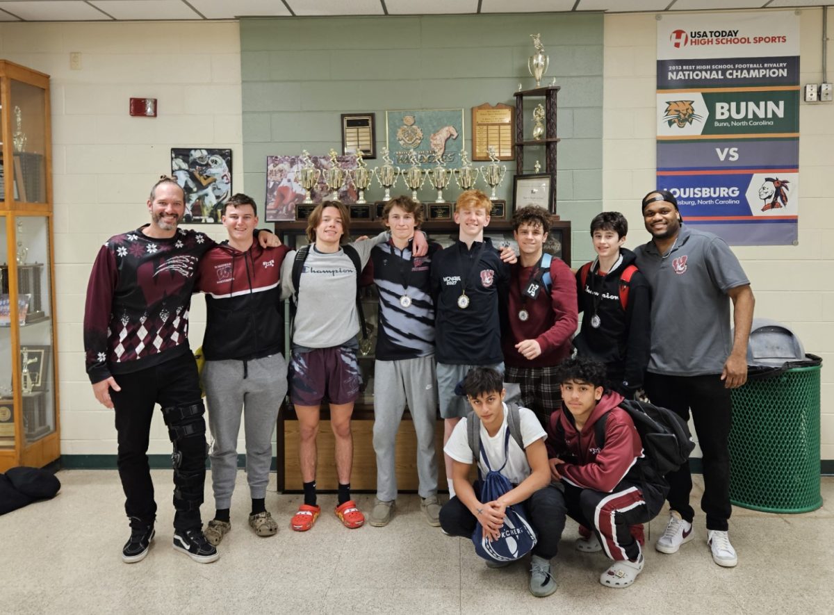 Wakefields men wrestlers pose for a photo after working hard in a match. The dedication by this close-knit team powers their achievements. (Photo Courtesy of Tim Meyer)