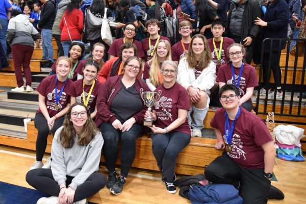 After competing at regionals, the Science Olympiad team poses for a photo with their trophy.The team celebrates their achievements and hard work after placing seventh overall.