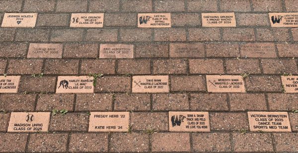 A collection of legacy brick line the football stadium entrance. Patrons of games can walk in and see the legacies past students and staff of the school. 