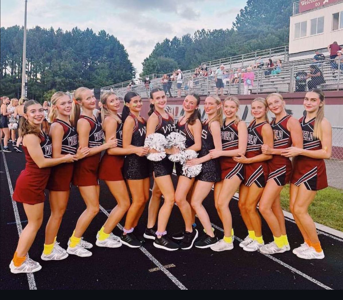 The cheer and dance teams pose together before performing at a Friday night football game. The theme was neon out. (Photo Courtesy of the Wakefield Dance Team)
