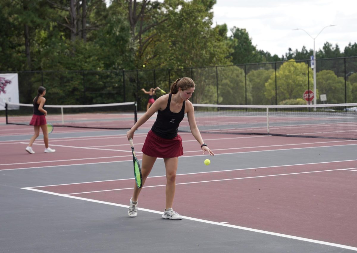 Senior Sierra Royalty prepares to serve the ball against her Knightdale opponent. Royalty's years of practice allow her to precisely aim the tennis ball.