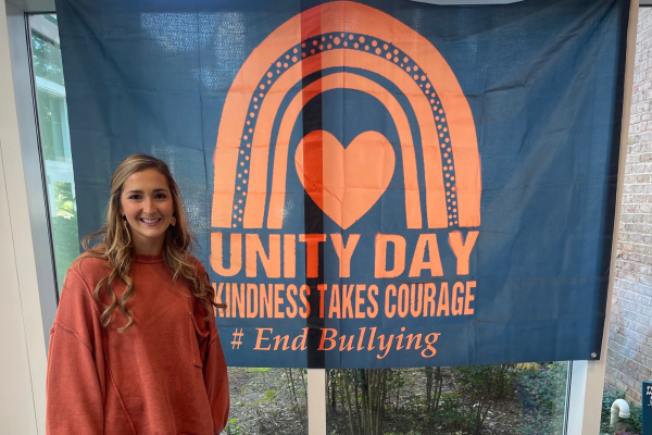 
Sara Veazie stands in front of a Unity Day sign during National Bullying Prevention Month. The counselors work to promote kindness, courage, and inclusion for all.