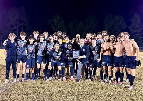 The men's soccer team poses for a picture after a win. They celebrate as they make school history by making the conference finals. (Photo courtesy of Tony Calabria)