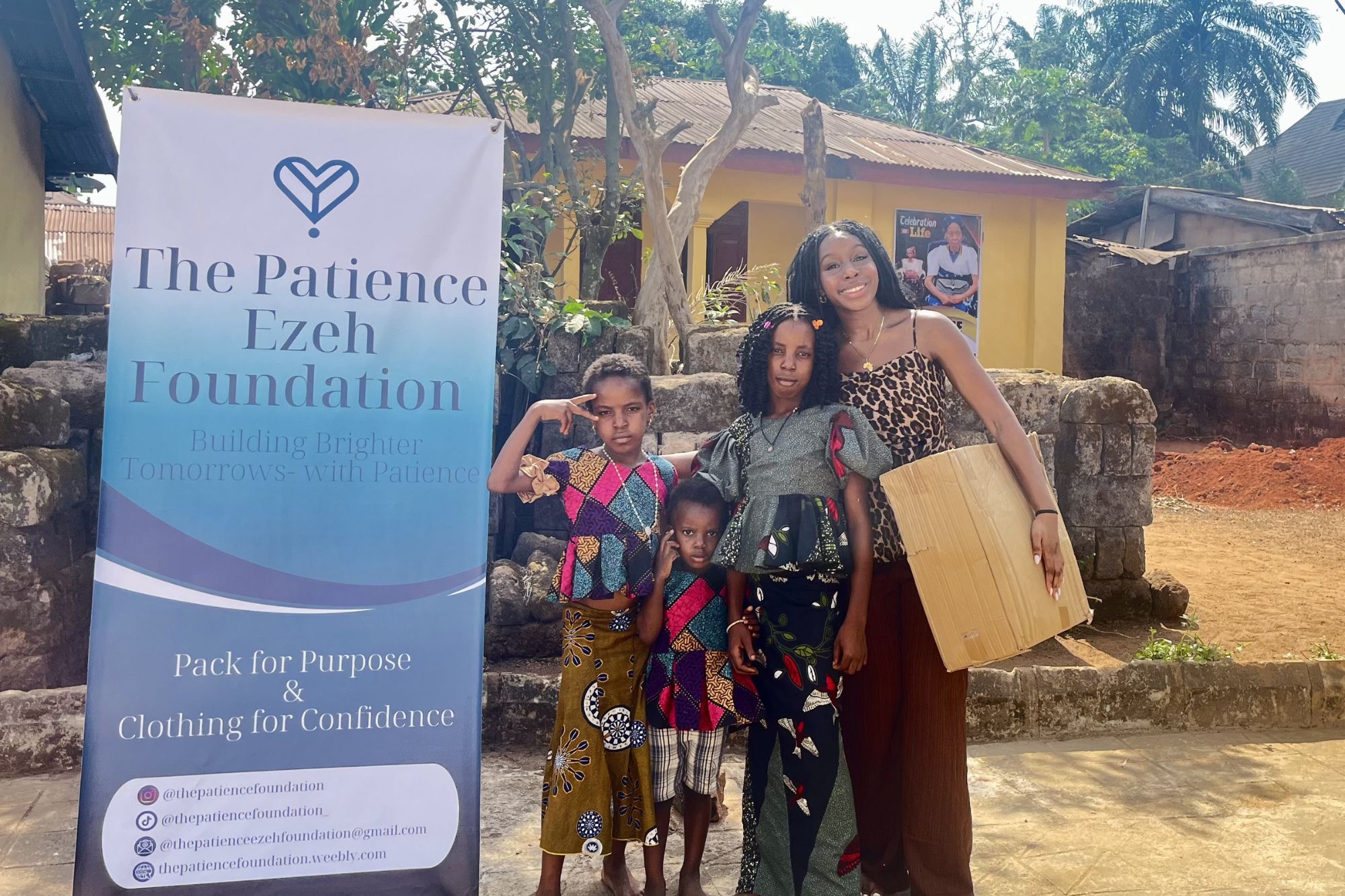 Angel Igboanugo (far right) in Okigwe, Nigeria on her donation trip. Here, she distributes school supplies and essentials to students. (Photo Courtesy of Angel Igboanugo)