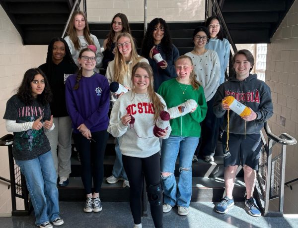 This is a photo of the Crochet Club. This photo shows them holding yarn and smiling in a hallway. ( Photo courtesy of Emmett Kelly )
