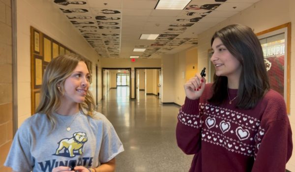 Rhoad (right) interviews fellow peer, Cameron Ledwith (left) for a service spotlight video. Interviewing is just one of many attributes of journalism Rhoad is skilled at, which will contribute to her success in the field. 
