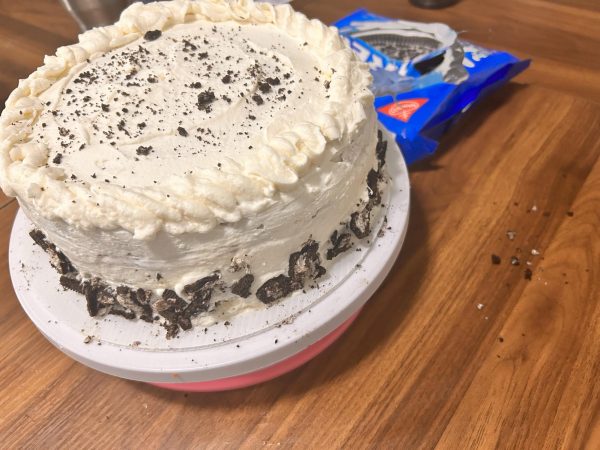 The cooled cake after decorating with crushed Oreos. As a cheat, use the oreos to cover any spots of uneven frosting.