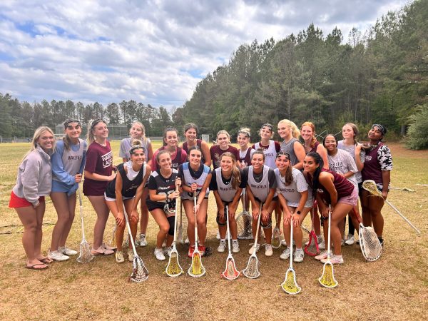 Wakefield women's lacrosse team posing during practice. Close friendships and teamwork are key to their success.